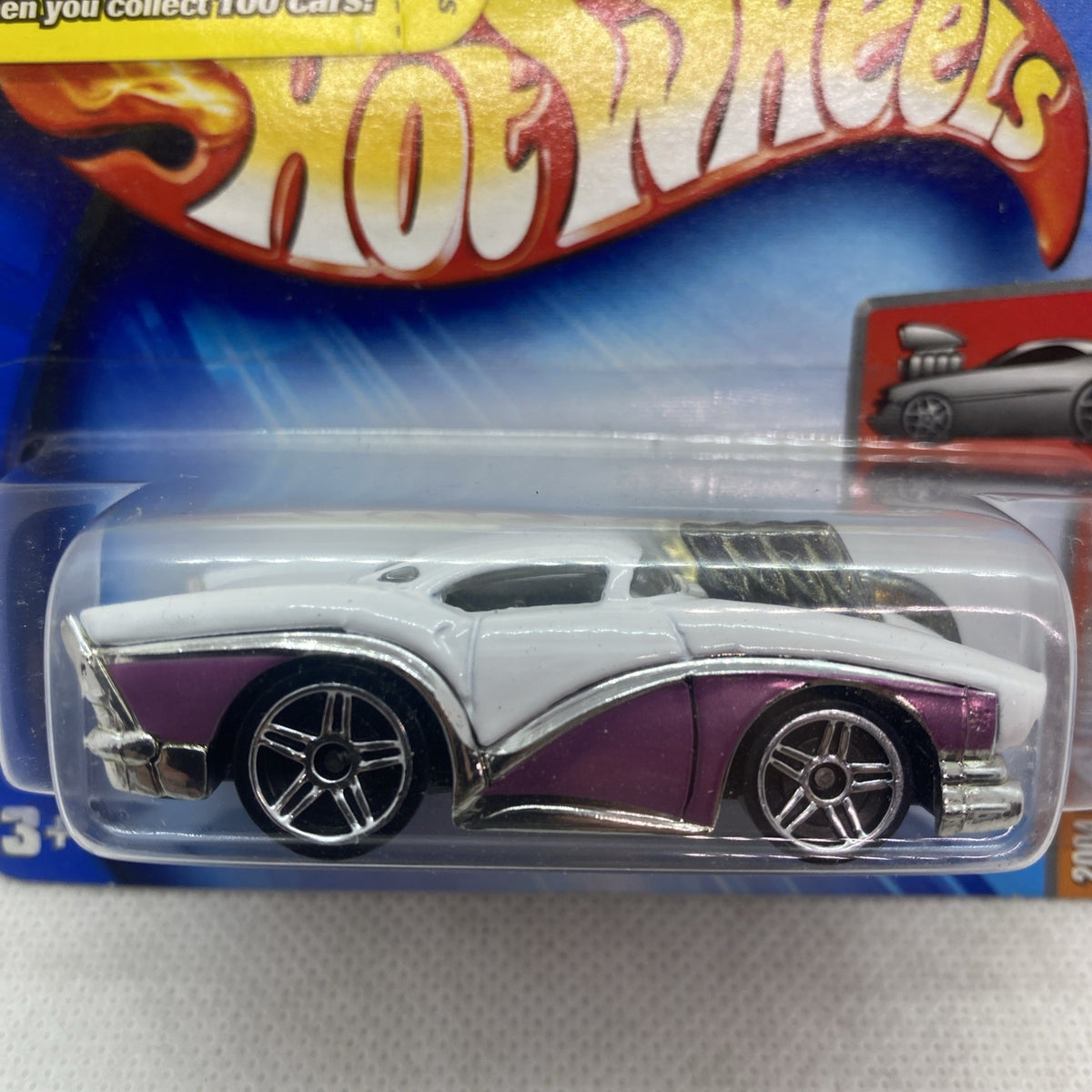 White and purple die-cast car in clear Hot Wheels blister package, angled view