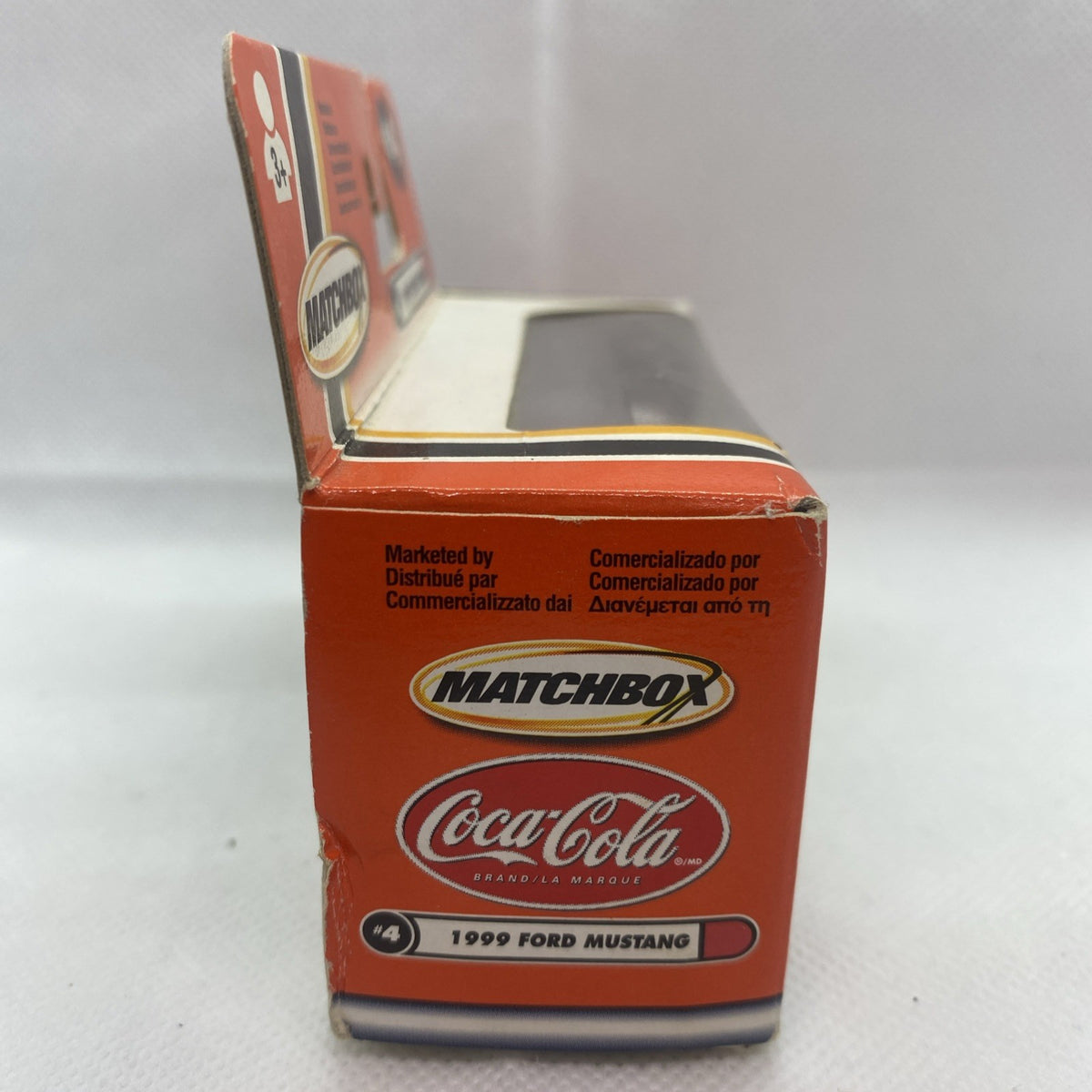 Orange Matchbox boxed die-cast Ford Mustang #4 Coca-Cola car, side view