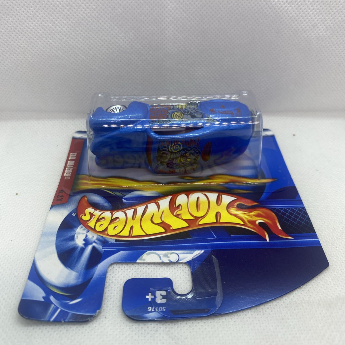 Hot Wheels blue tail-dragger die-cast car in sealed blister card, side view.