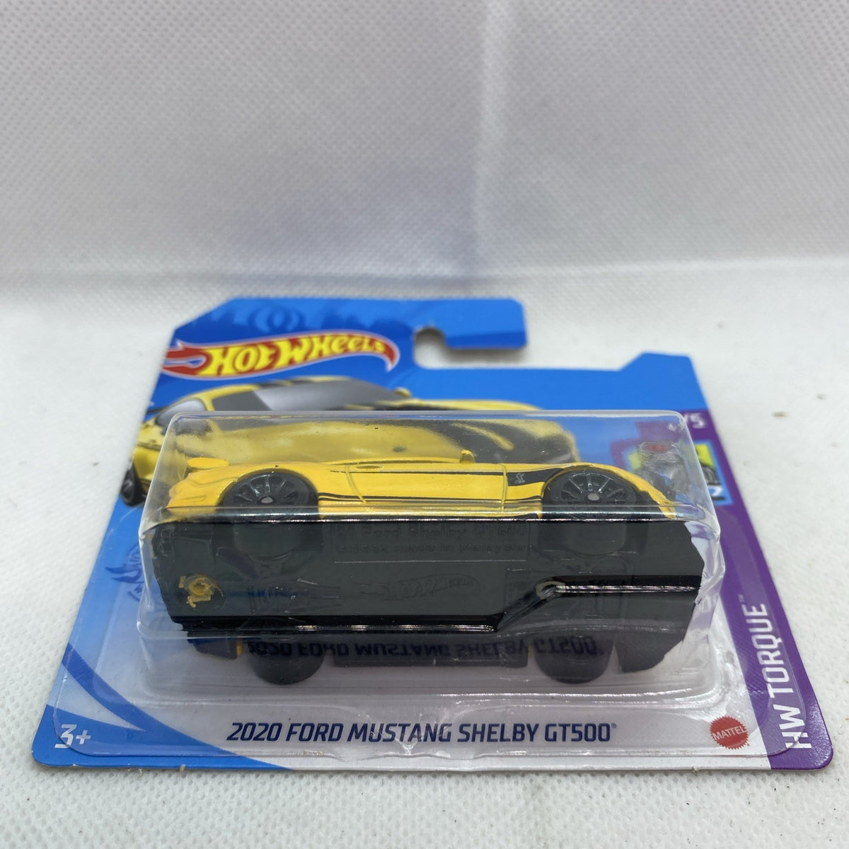 Yellow and black die-cast muscle car in blister package, side view