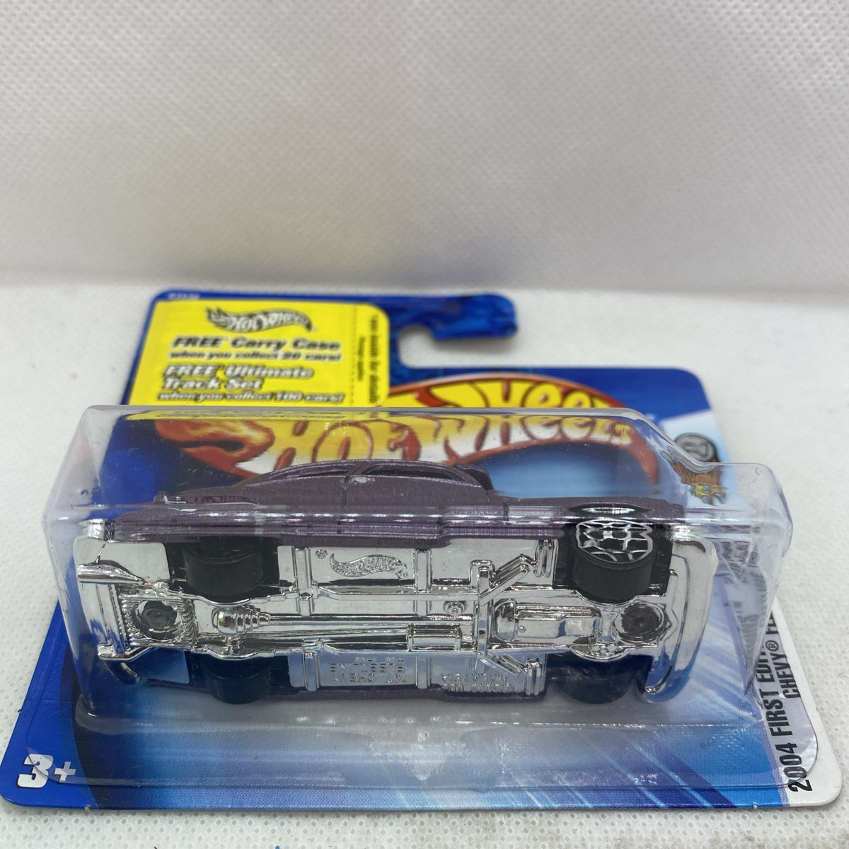 Hot Wheels diecast car blister pack with chrome underside view of purple car