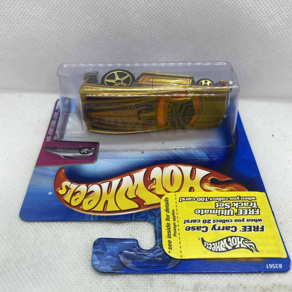 Hot Wheels die-cast car in clear blister, yellow body with black accents and wing