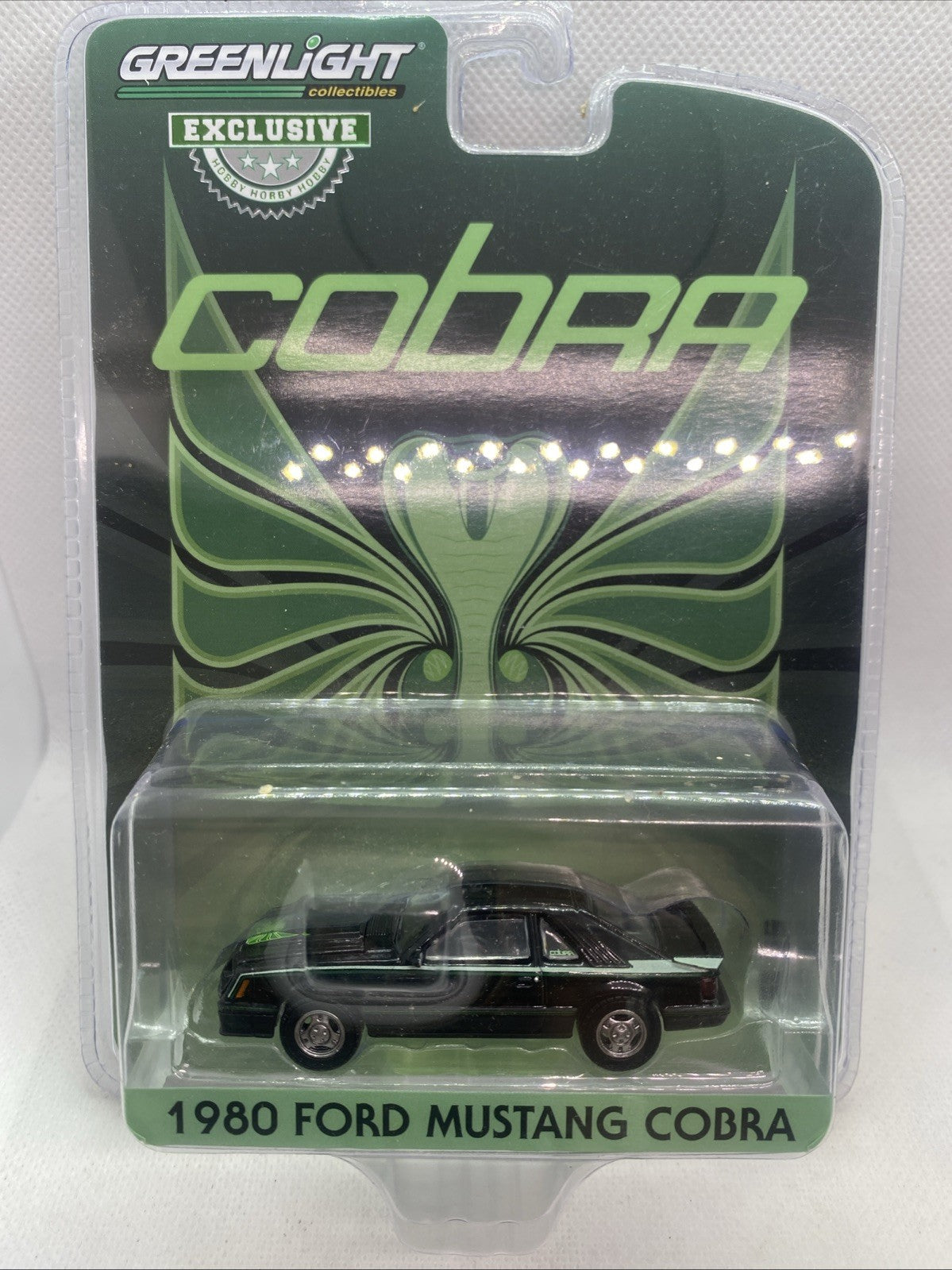 Die-cast 1980 Ford Mustang Cobra model car in green blister package