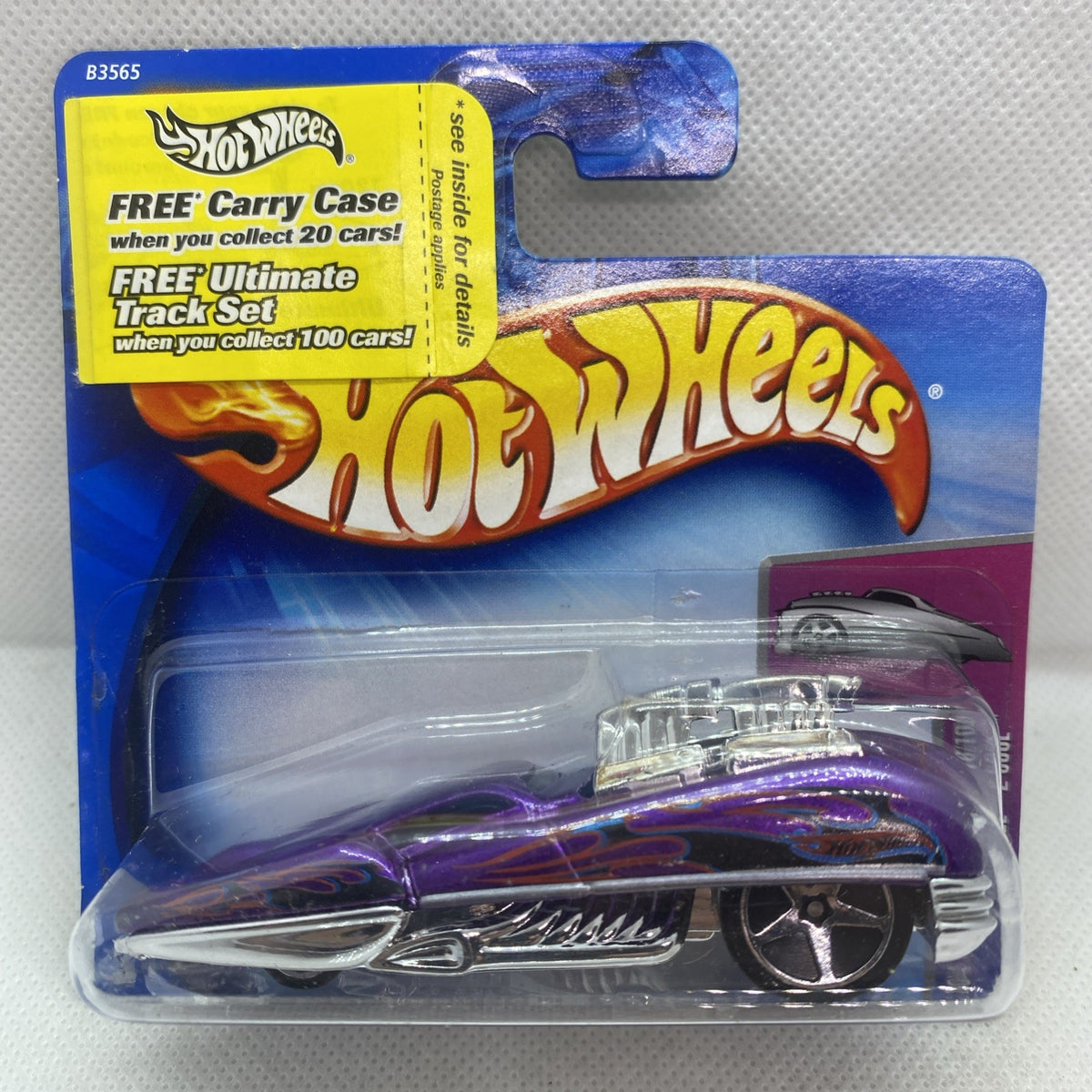 Hot Wheels die-cast car in clear blister on blue card, black body with purple flames