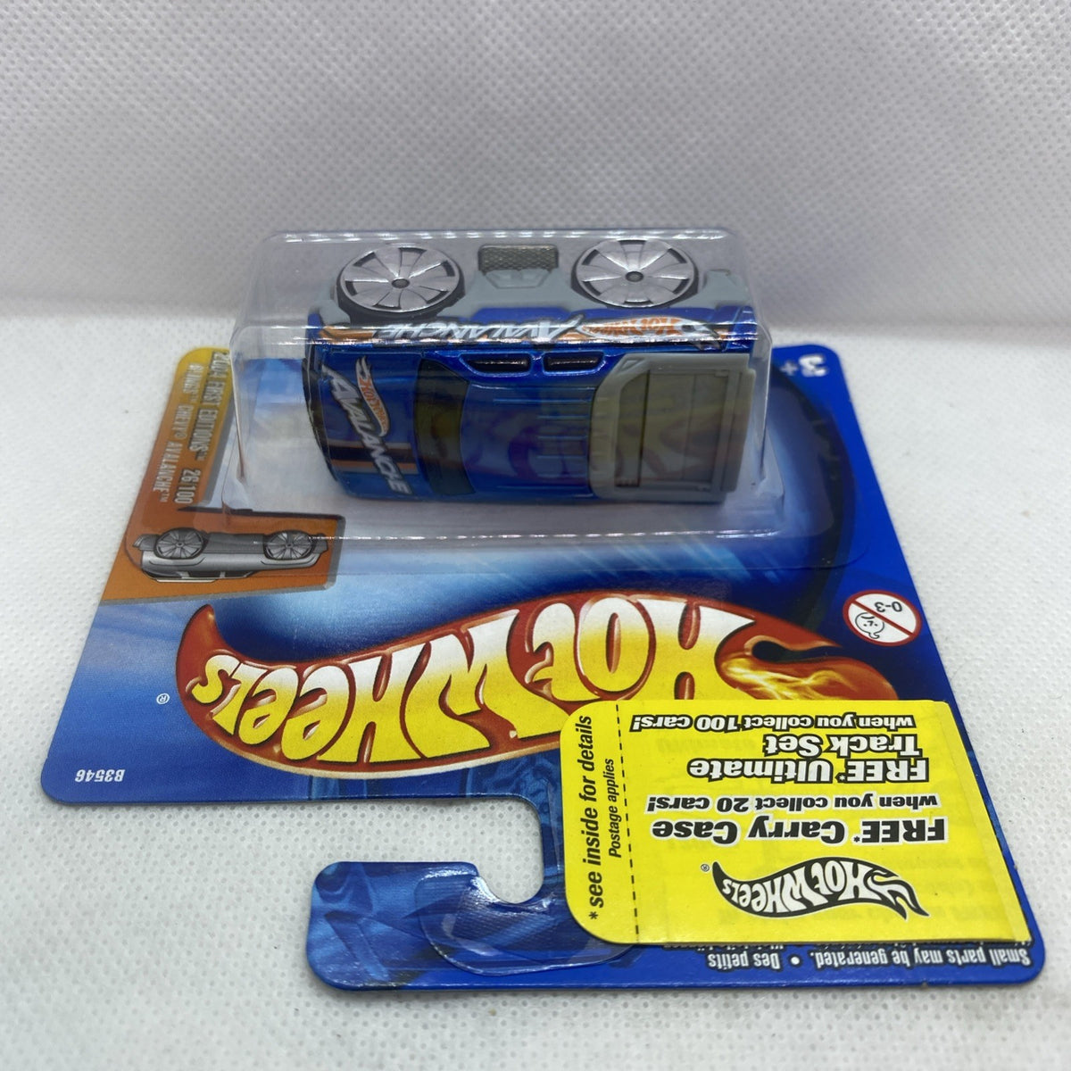Hot Wheels die-cast pickup car side view in blister pack, blue body and silver wheels