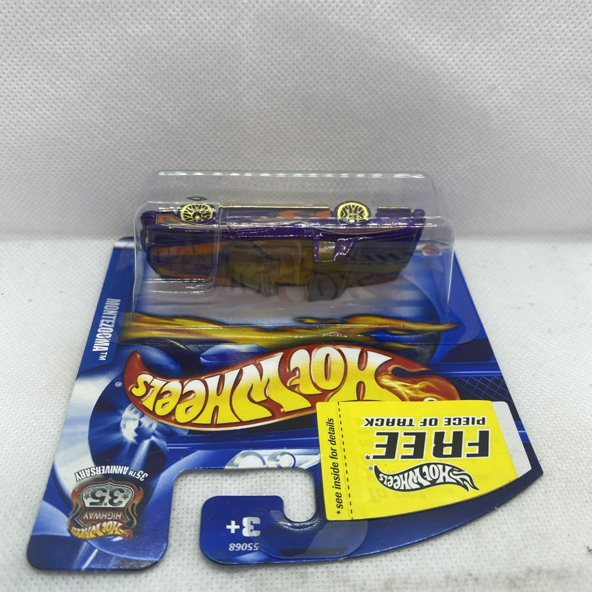 Hot Wheels blister card with metallic purple and gold die-cast car, top view
