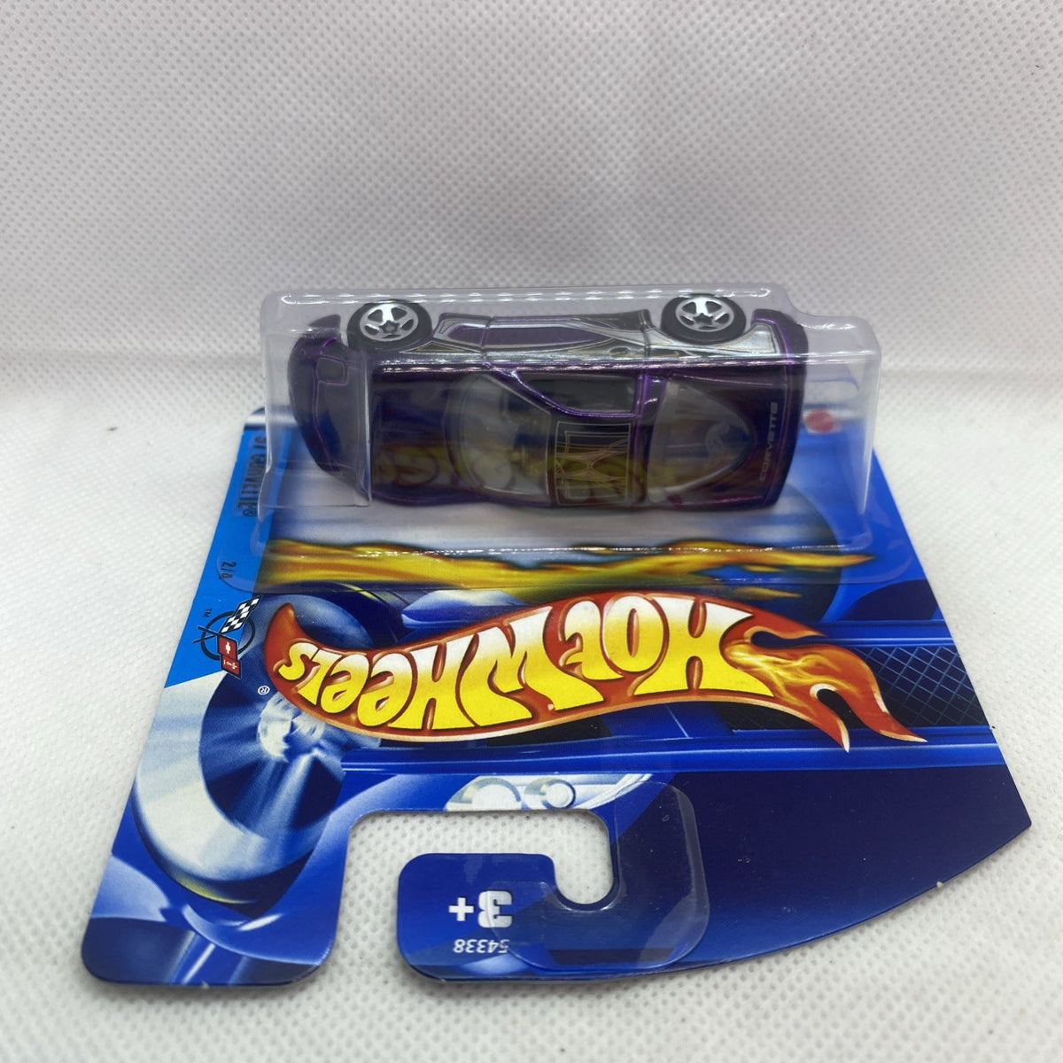 Purple and black Corvette die-cast under clear blister on blue Hot Wheels card
