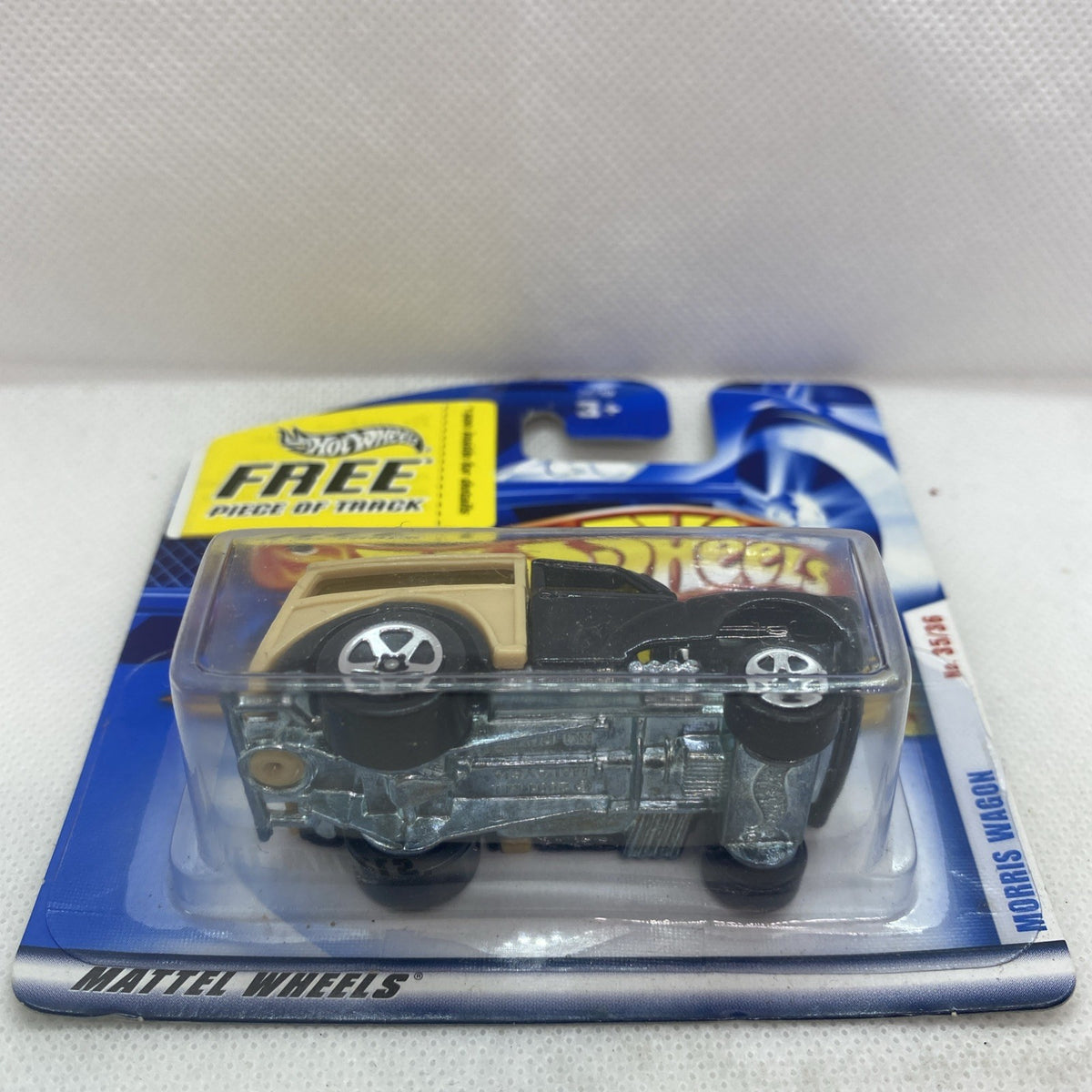 Sealed blister package with black and tan Morris Wagon die-cast, wheel rims visible