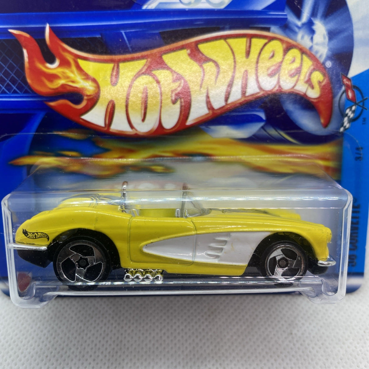 Hot Wheels 2002 Corvette #069 yellow die-cast car close-up in clear blister