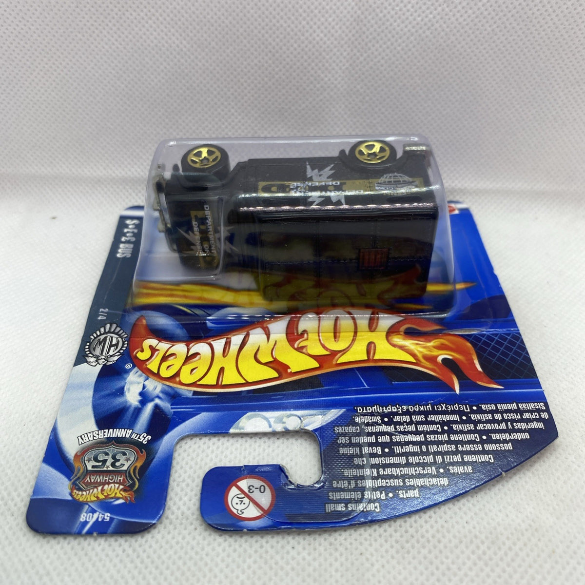 Hot Wheels armored truck die-cast in sealed blue blister card, side view, black and yellow