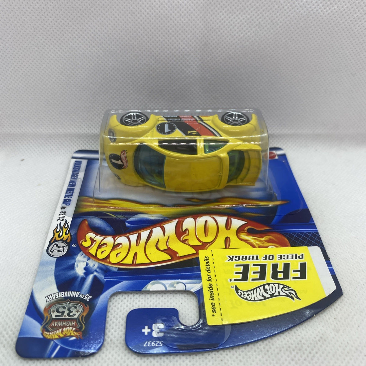 Hot Wheels yellow New Beetle die-cast car in blister pack, front view