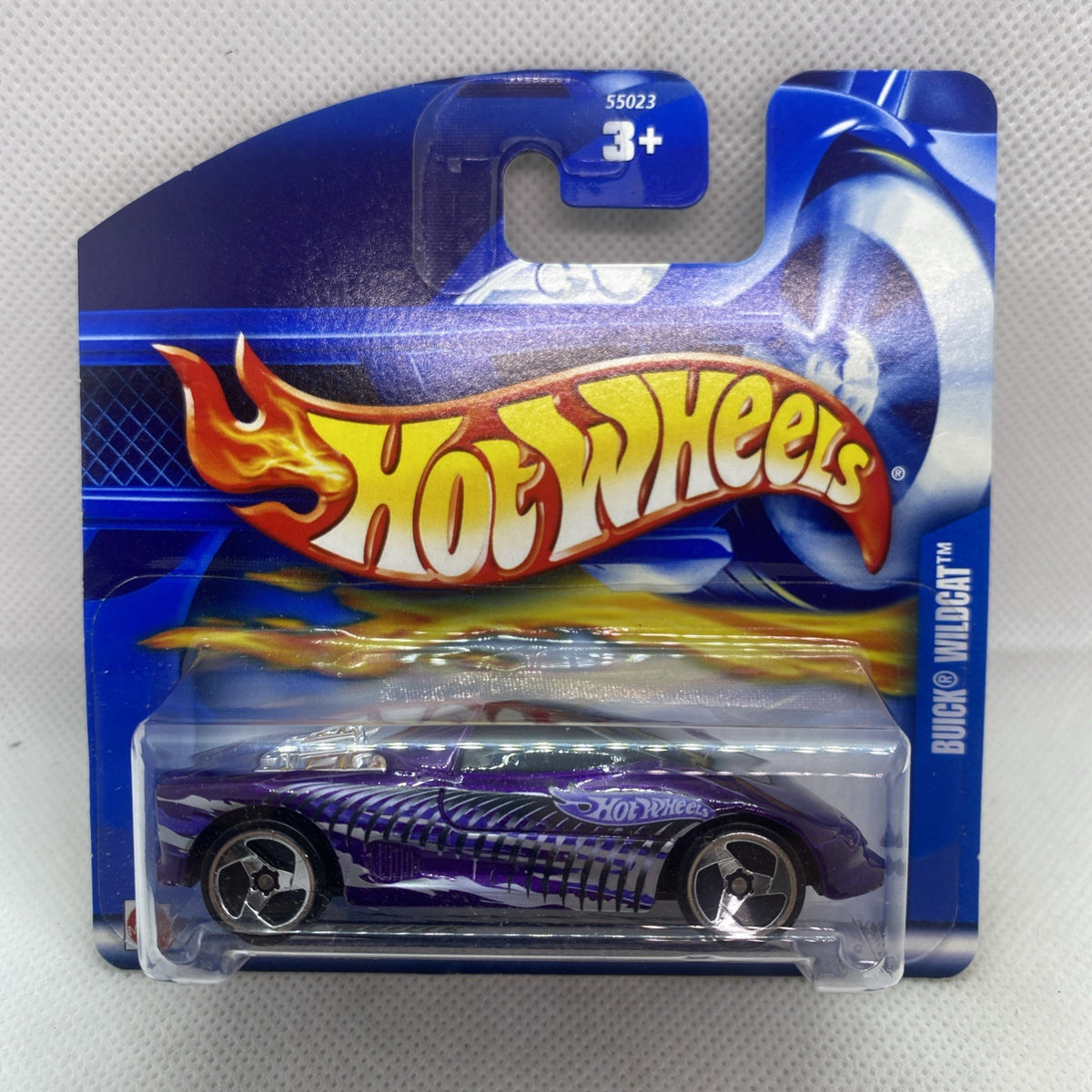 Hot Wheels die-cast car in purple blister pack, flame graphics and silver wheels