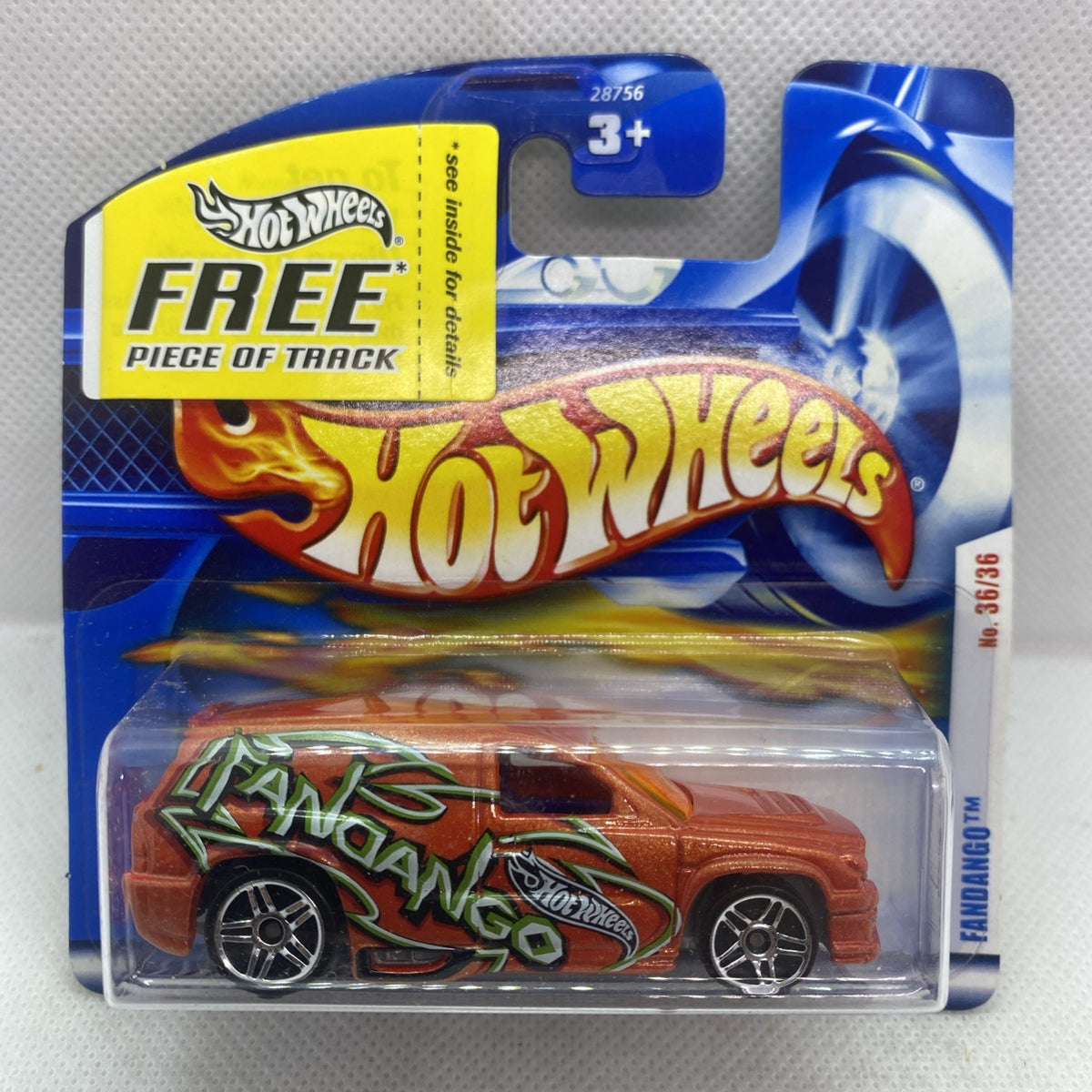 Hot Wheels die-cast car on short card, orange body with green graffiti-style graphics