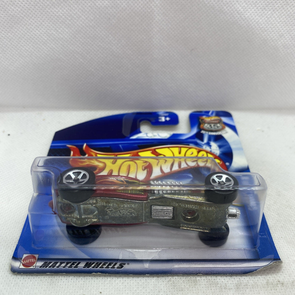 Hot Wheels die-cast car blister pack with rear view of maroon car and chrome details