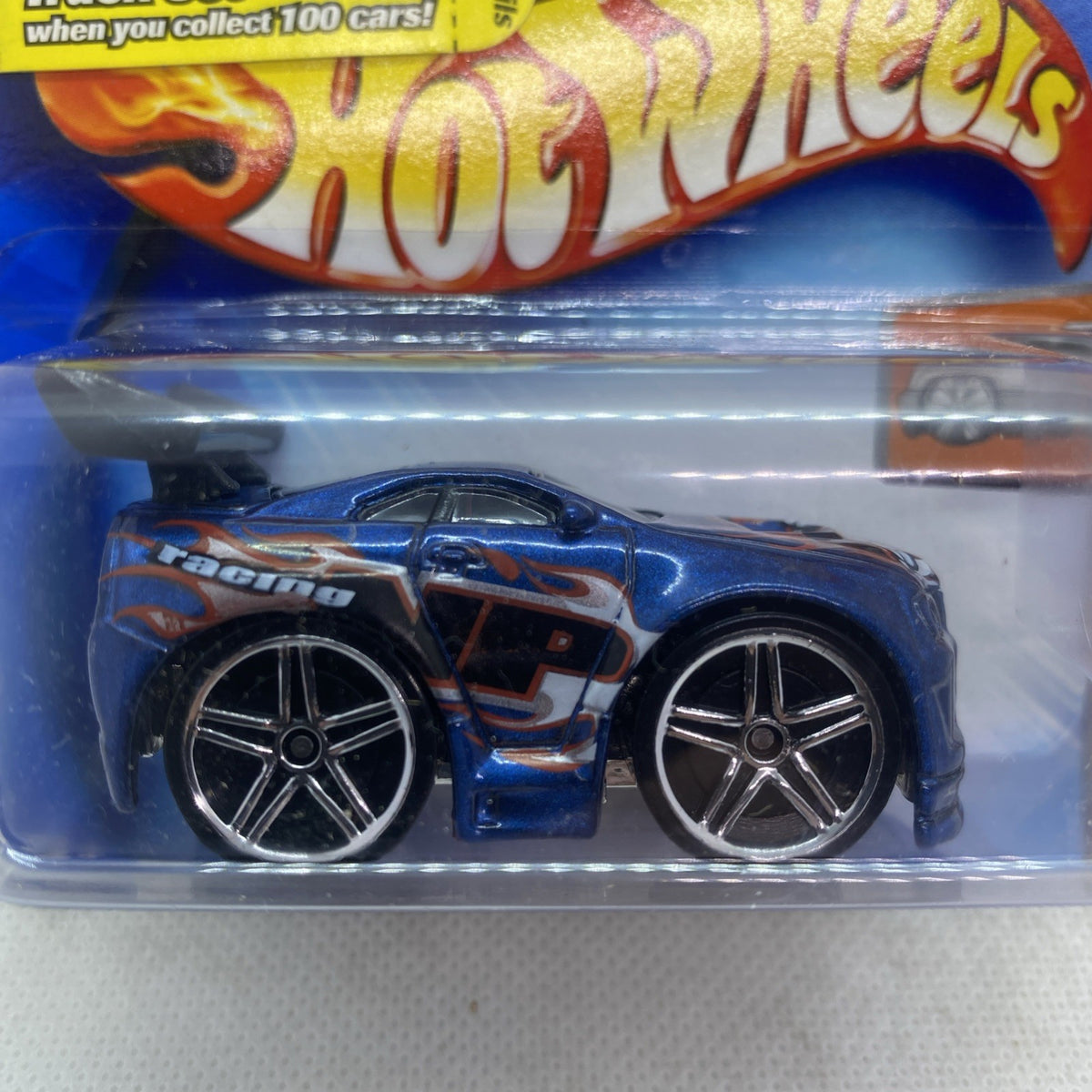 Hot Wheels die-cast car with blue flame graphic, dark grille, and chrome five-spoke wheels
