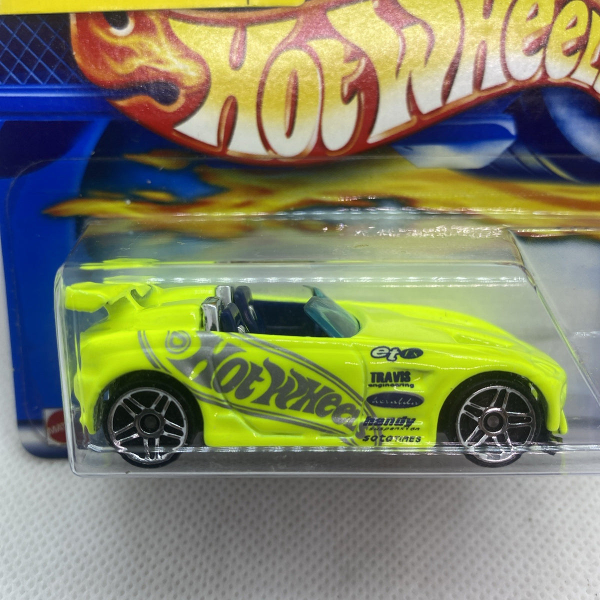 Hot Wheels neon lime die-cast car close-up in clear blister with chrome wheels