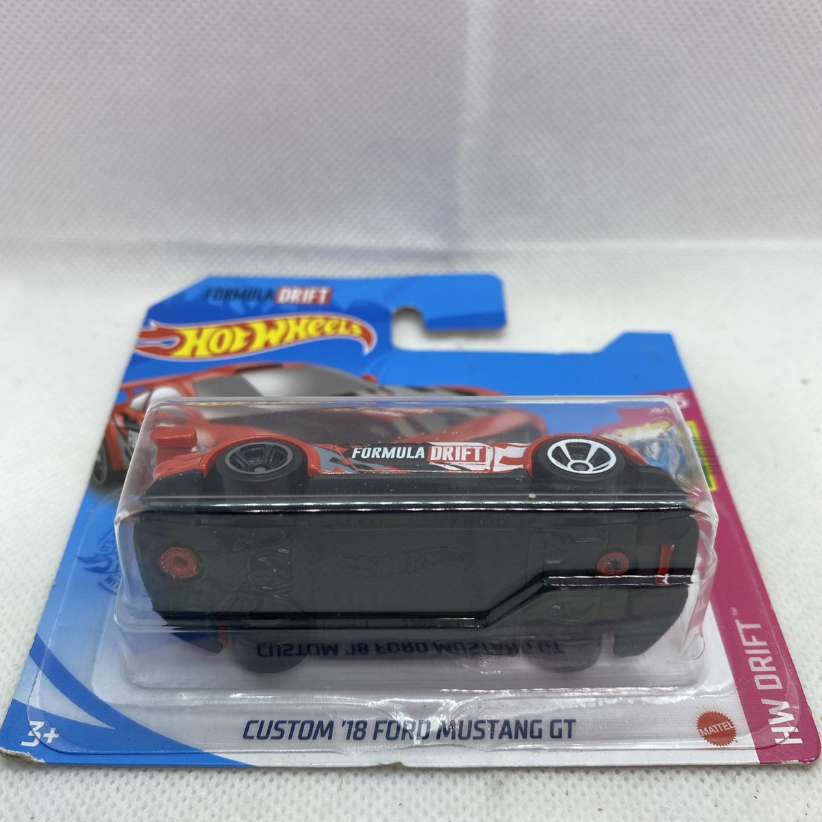 Hot Wheels Formula Drift die-cast car in front blister, orange stripe decals