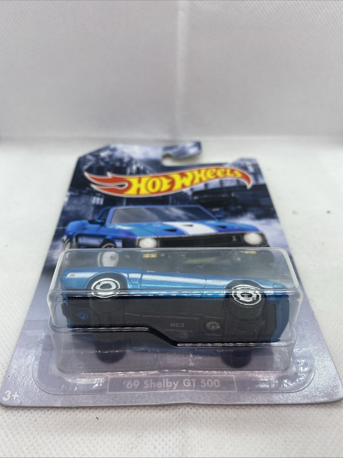 Blue '69 Shelby GT500 Hot Wheels die-cast car shown through clear front blister