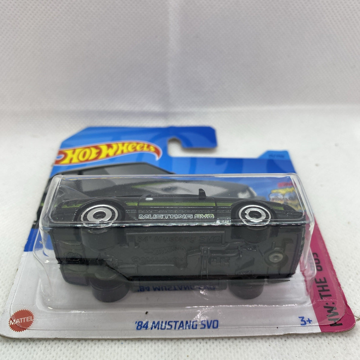 Black '84 Mustang SVO die-cast with green stripes in clear blister