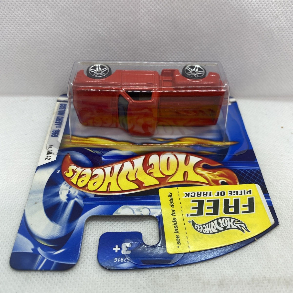 Red Hot Wheels die-cast car in blister with chrome wheels and hood details