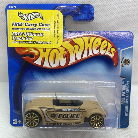 Hot Wheels police die-cast car in beige with black roof and gold wheels on blue card