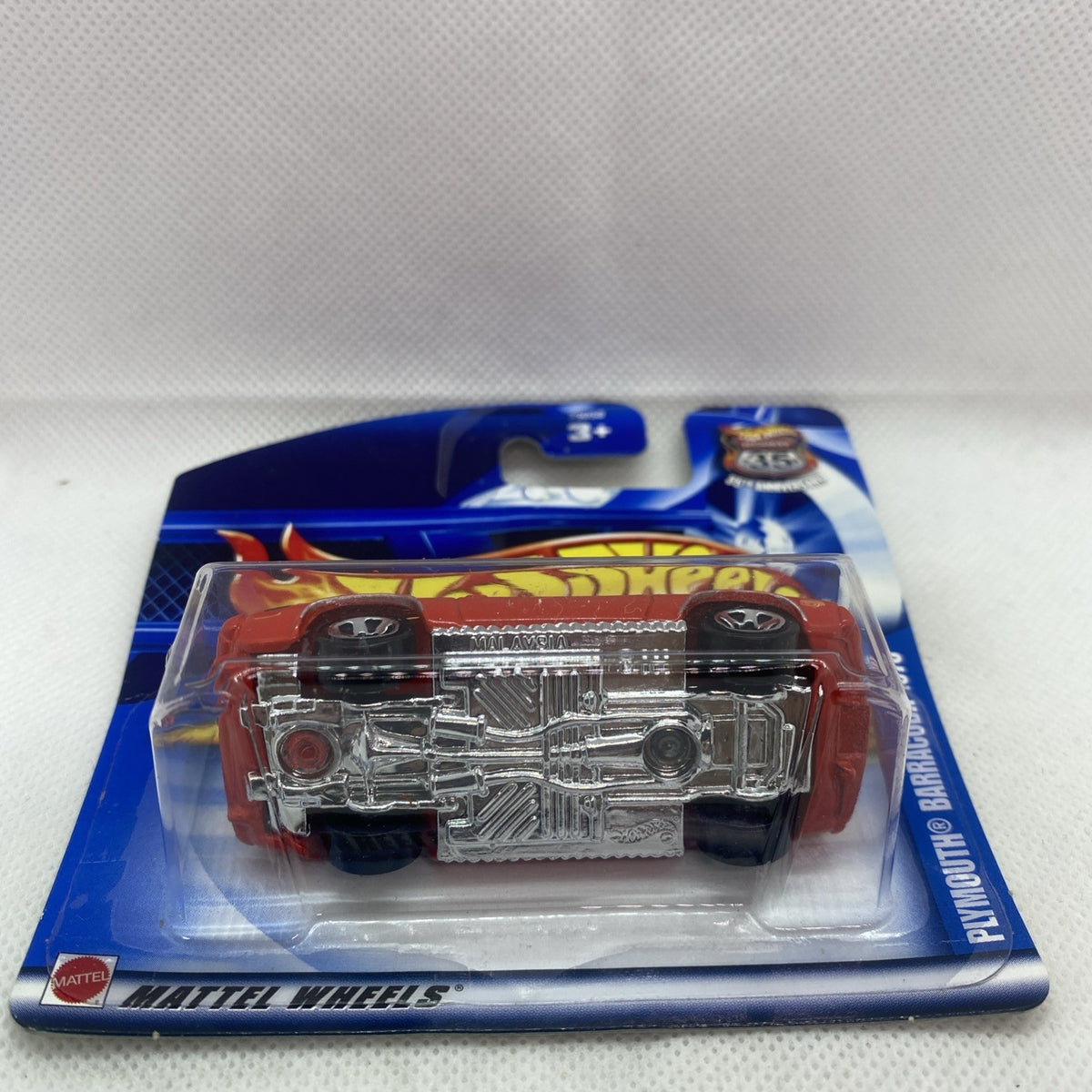 Red Hot Wheels car with exposed chrome engine in clear blister pack