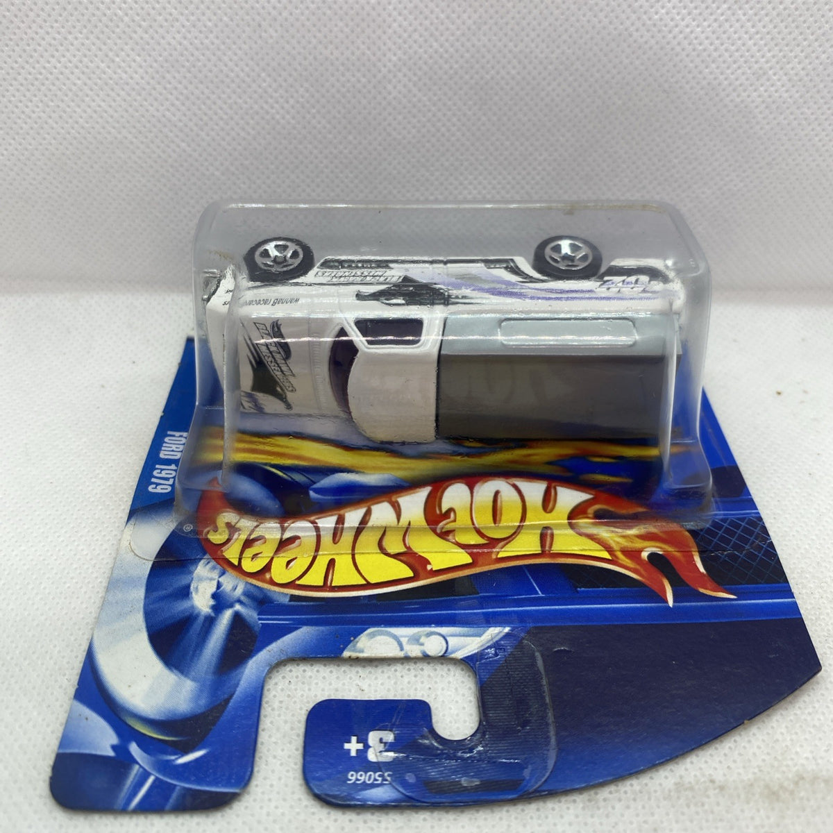 Hot Wheels die-cast pickup truck card, silver truck with flame logo on backing