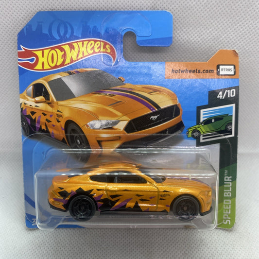 Hot Wheels Speed Blur orange die-cast car on blue card, side view under clear blister.