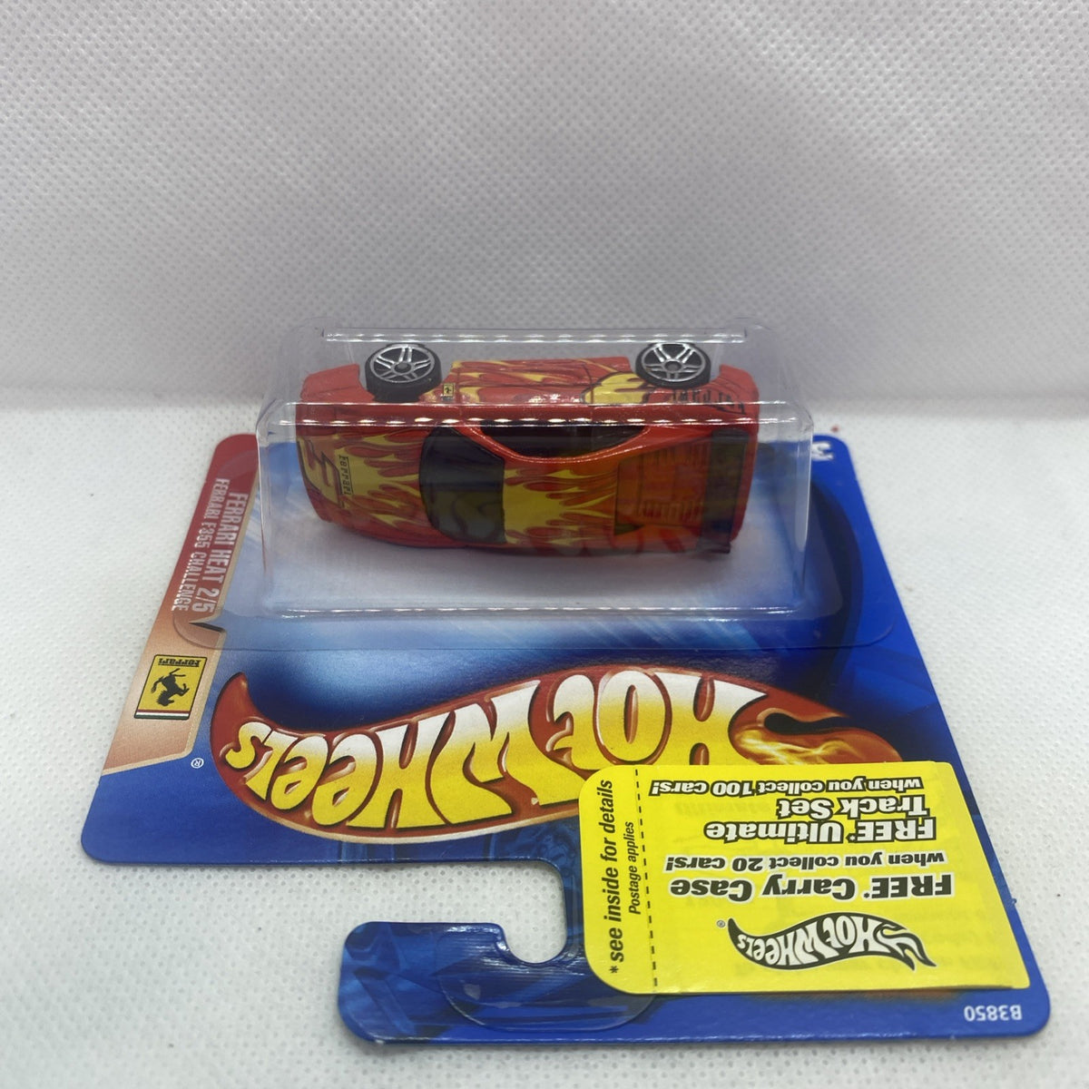 Red Hot Wheels Ferrari die-cast car viewed from above in clear blister pack