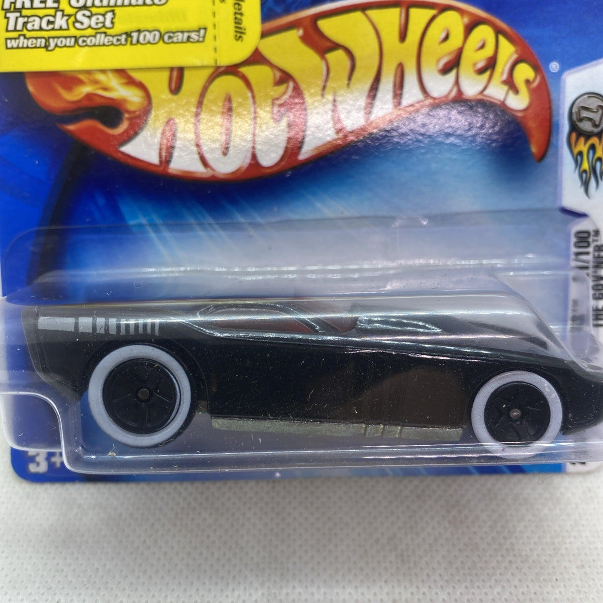 Hot Wheels die-cast car close-up, black body with silver stripes and white wheel hubs