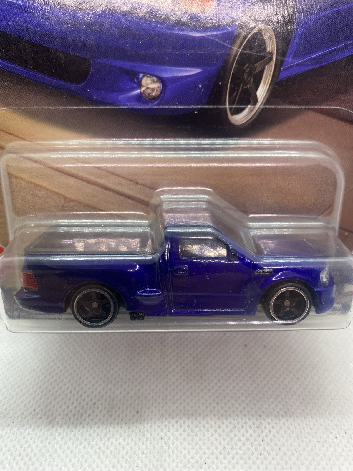 Blue F-150 SVT Lightning die-cast truck close-up in clear blister