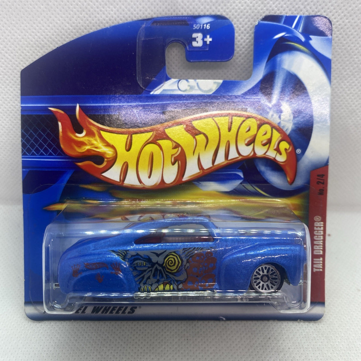Hot Wheels blue tail-dragger die-cast car in sealed blister card with flame logo.