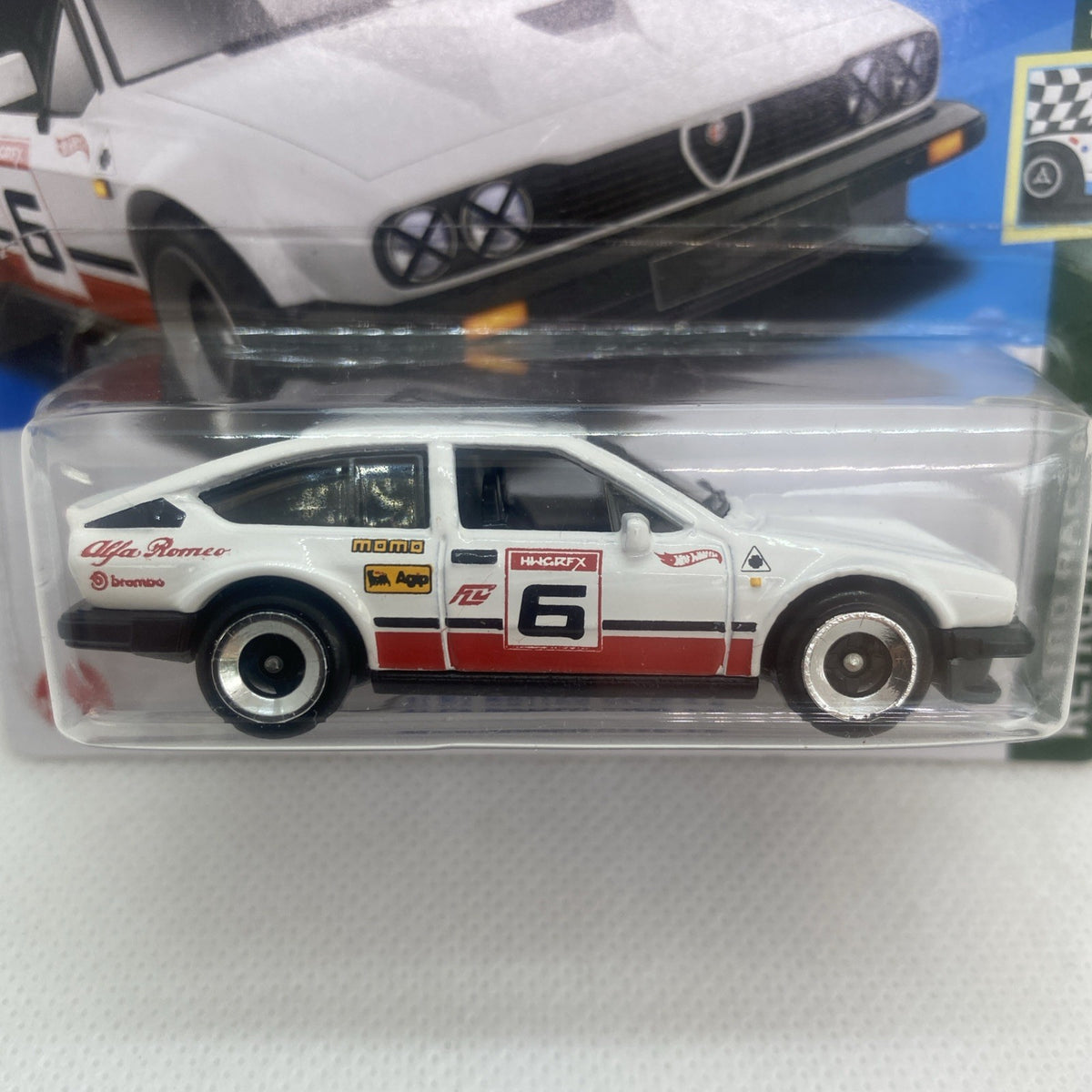 Hot Wheels Alfa Romeo GTV6 race car blister close-up, white, red, and number 6