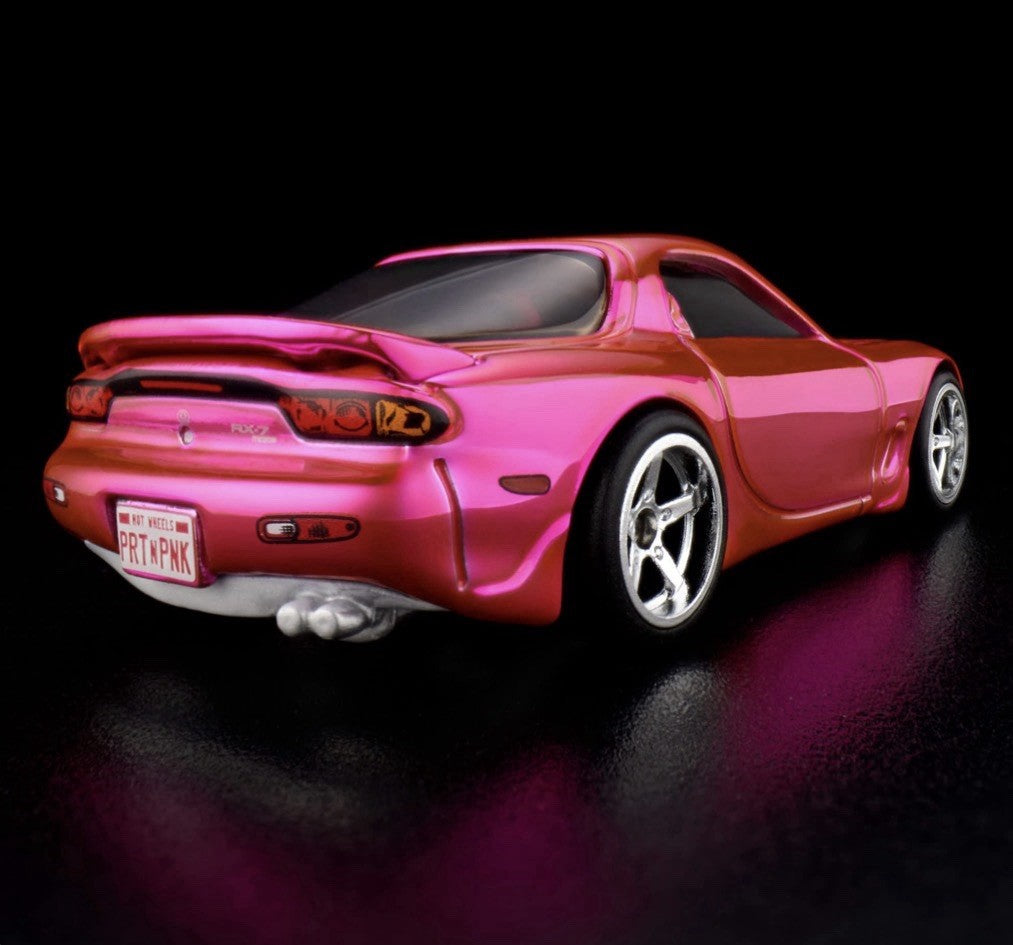 Pink die-cast sports car rear 3/4 view, chrome wheels and exhaust