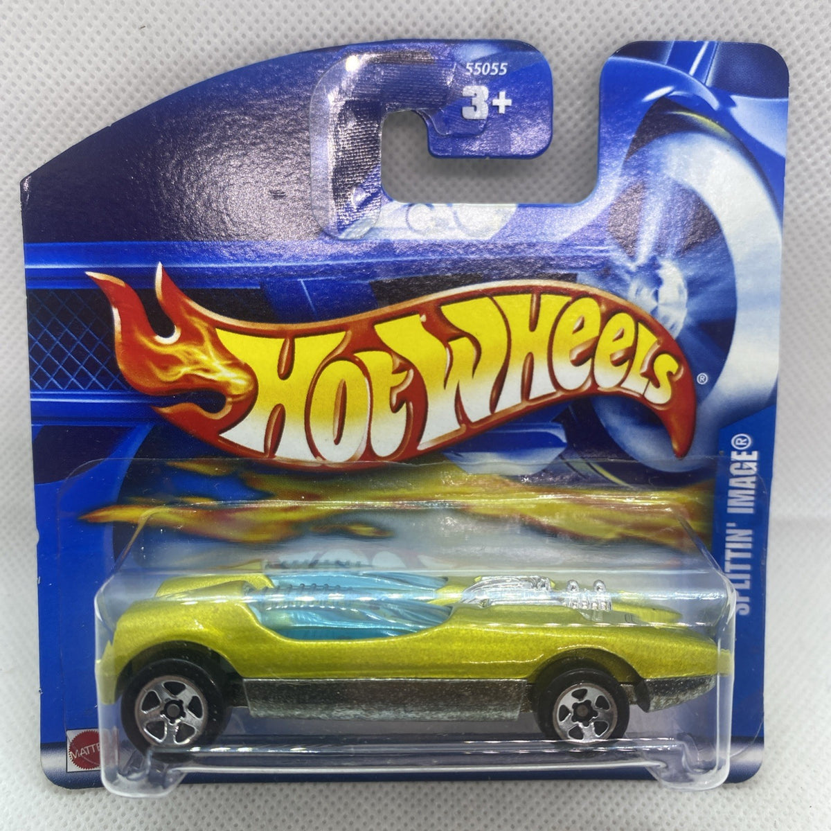 Green Hot Wheels die-cast car in blue blister pack, front flame graphics