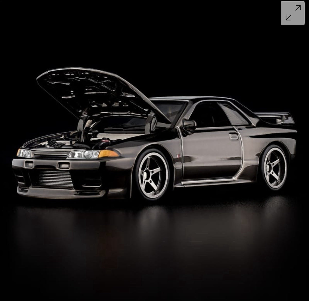 RLC Nissan Skyline GT-R model car in gray, side 3/4 view, hood open