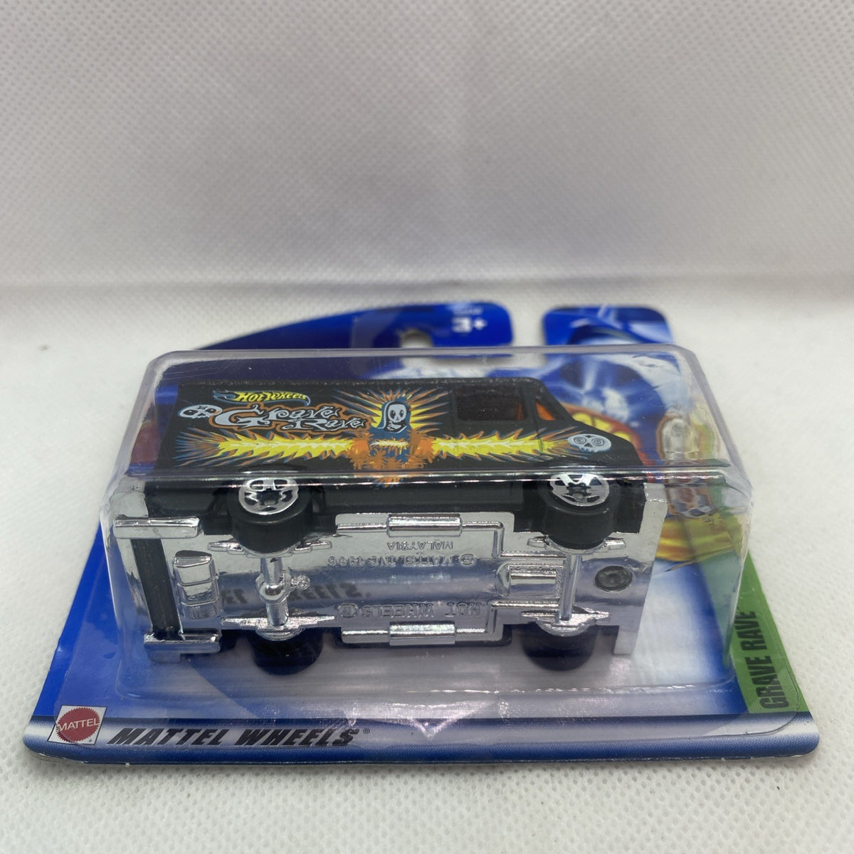 Hot Wheels Grave Rave car underside in blister pack, gray underside and wheels visible