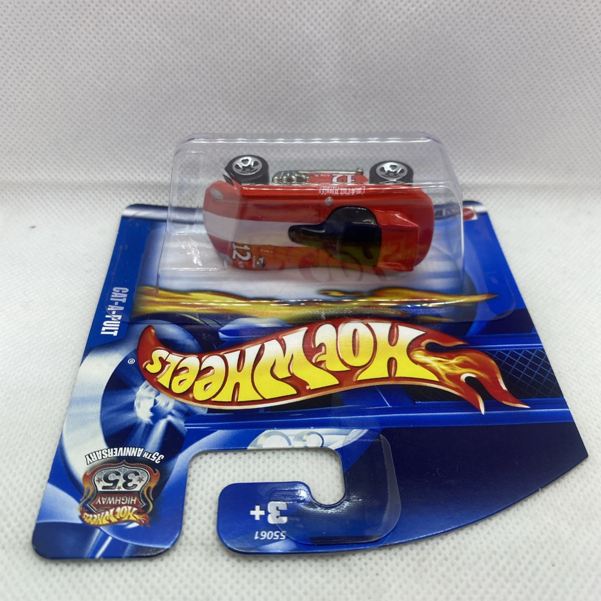 Hot Wheels red die-cast car sealed in clear blister on blue short card