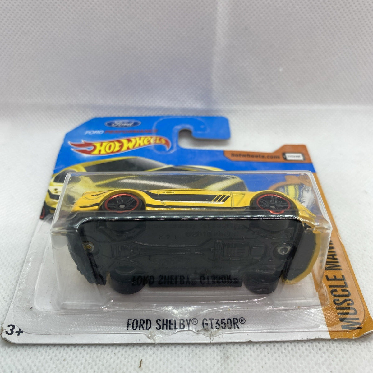 Yellow Hot Wheels muscle car blister on blue card with Ford Shelby GT350R label