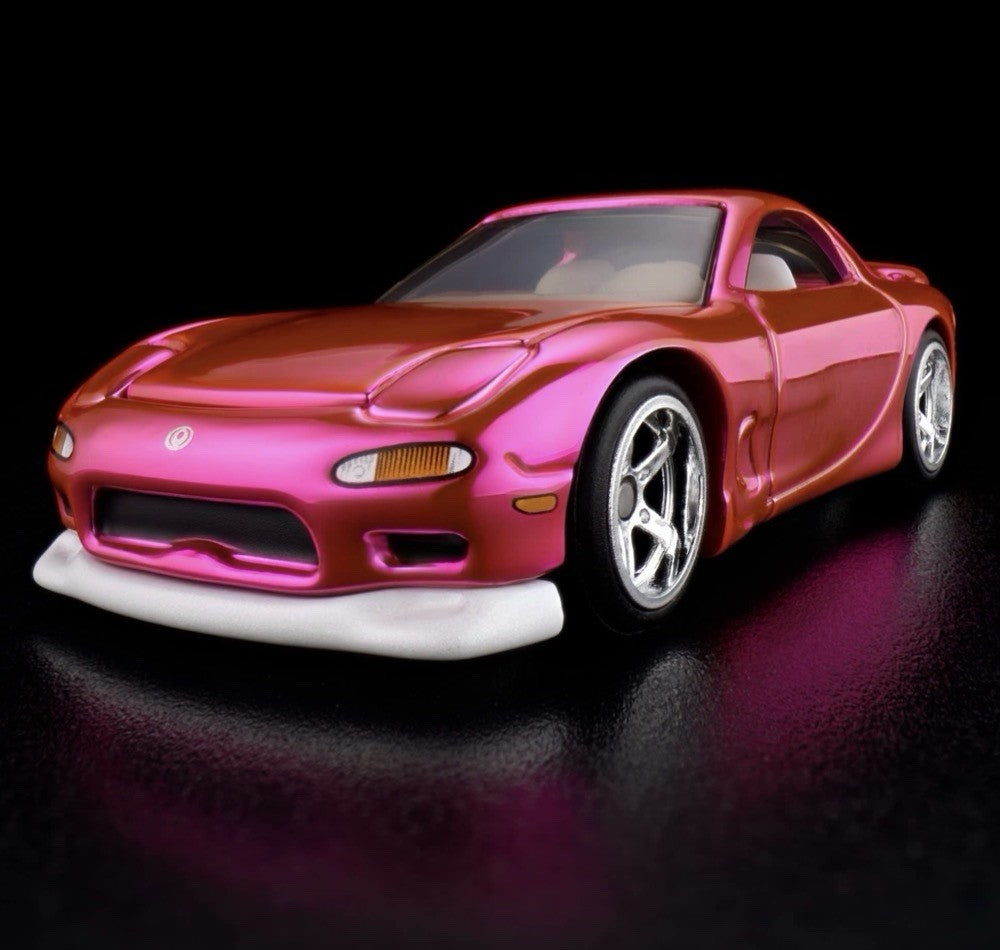 Pink and orange die-cast sports car with chrome wheels, front 3/4 view