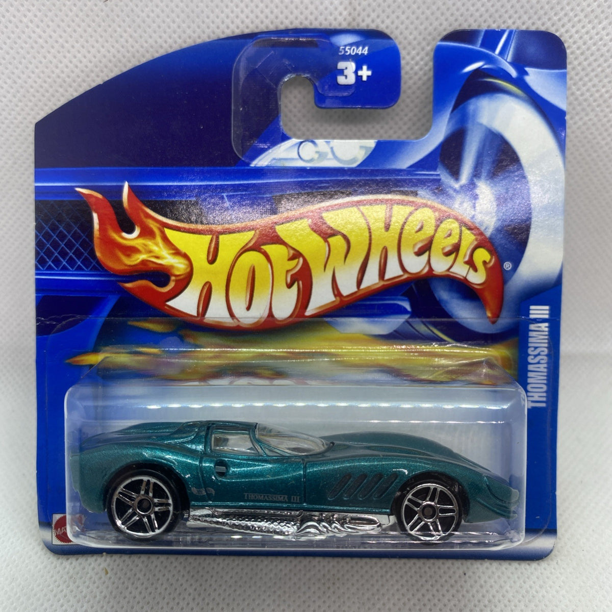 Hot Wheels die-cast car blister: green sports car, silver wheels