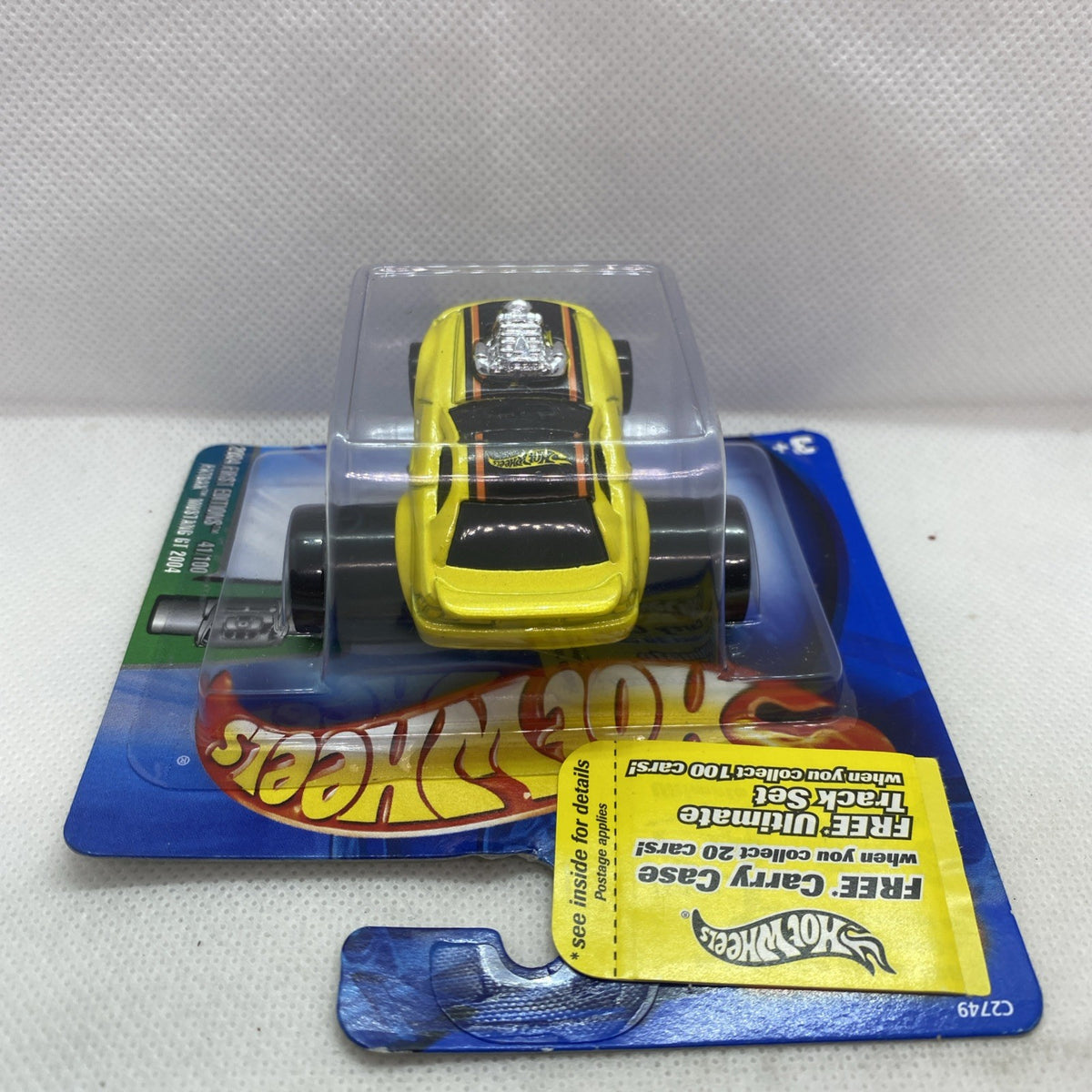 Yellow Mustang GT toy car in clear blister, front-on view on blue card