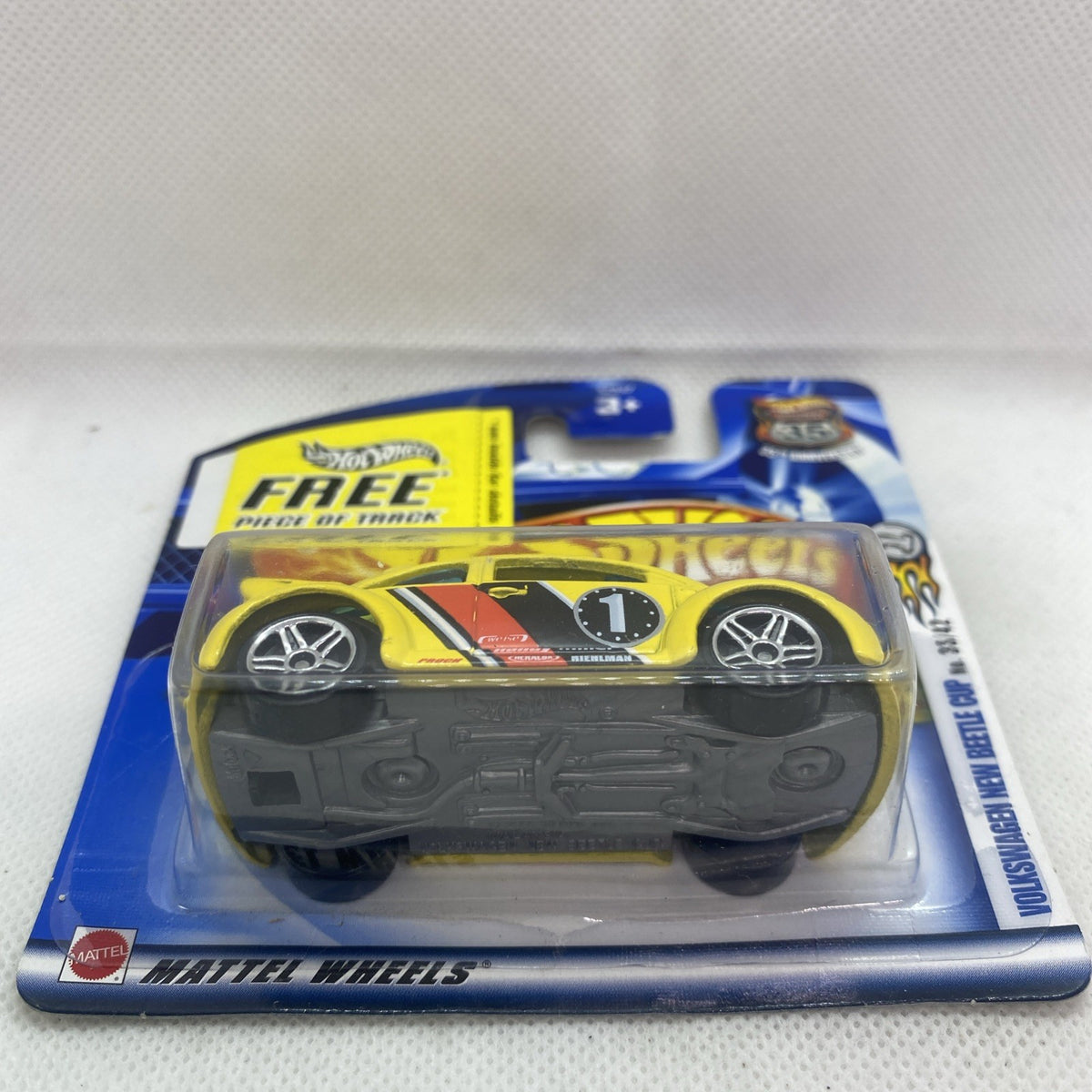 Hot Wheels yellow New Beetle die-cast underside in blister pack, reverse view