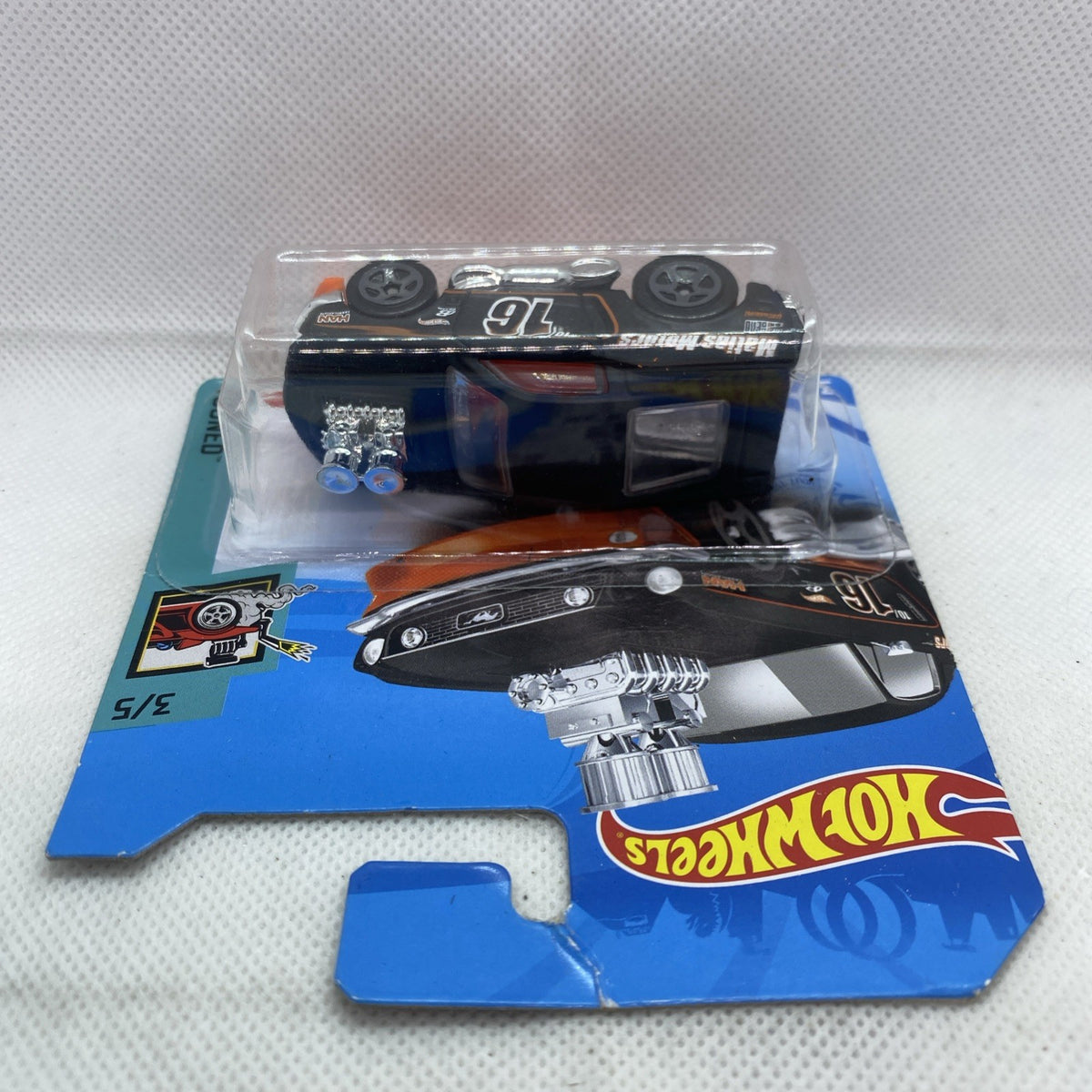 Hot Wheels ’68 Mustang die-cast in clear blister on blue short card backing, black and orange