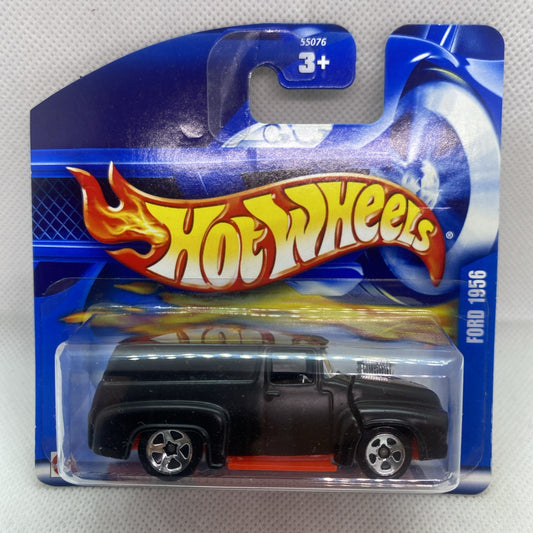 Hot Wheels die-cast truck in blue blister with flames graphics, black body, red stripe