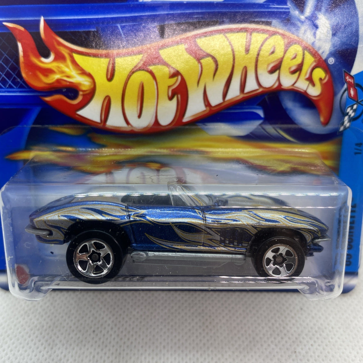 Hot Wheels die-cast Corvette on blue short card, close-up of car and flame logo