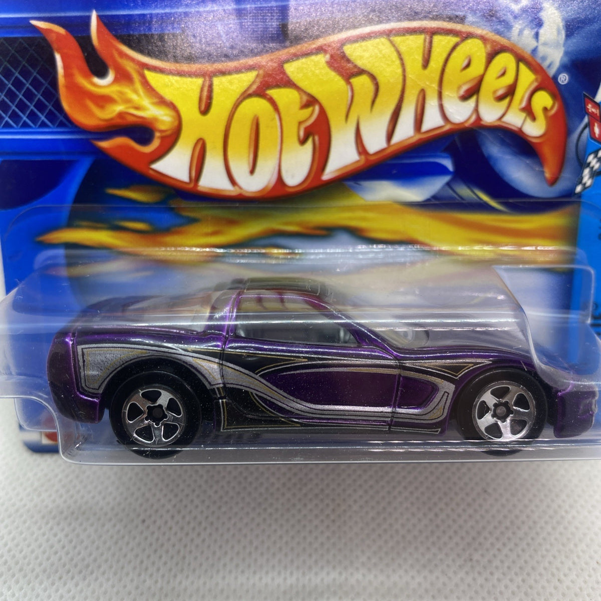 Purple and black Corvette die-cast in clear blister with Hot Wheels flame logo