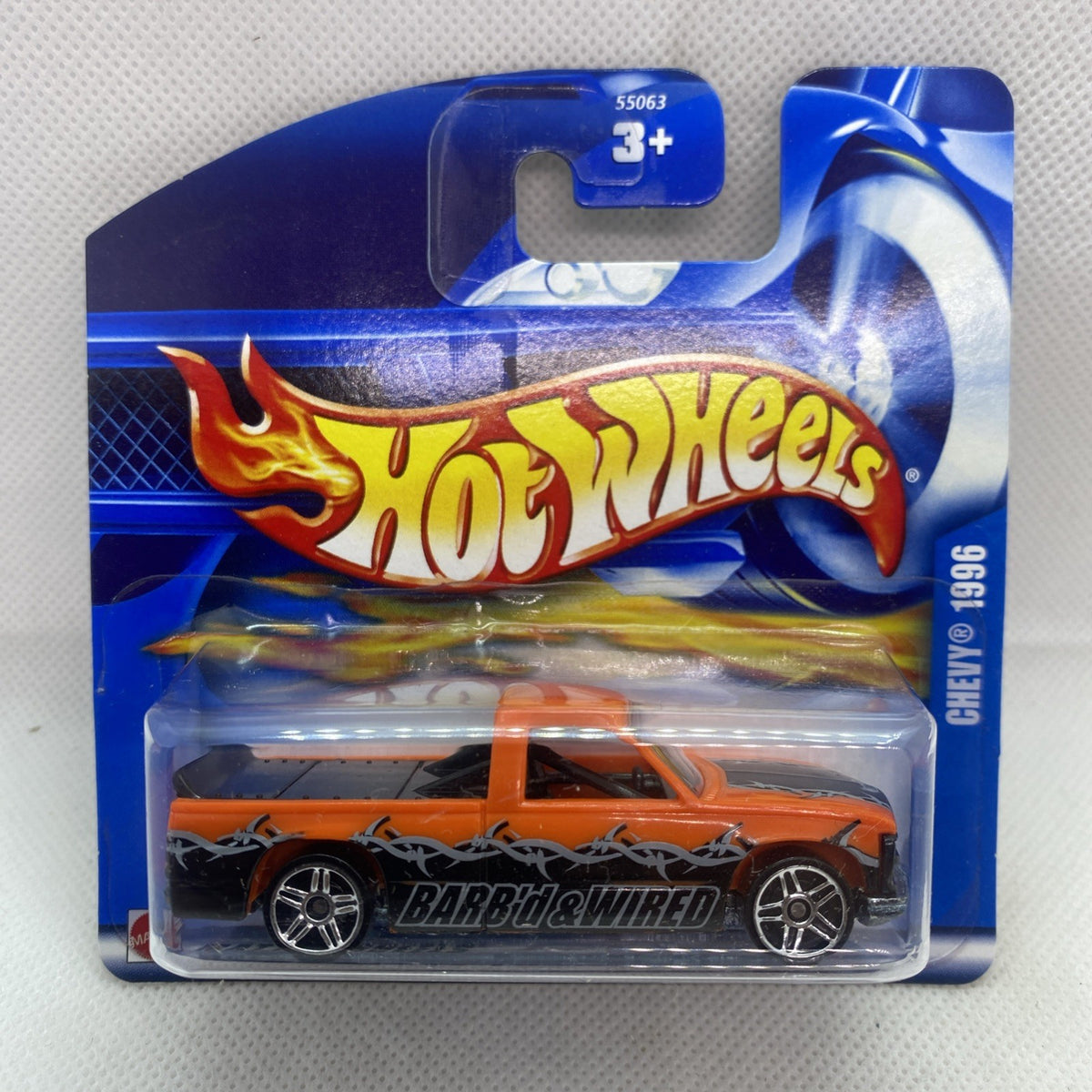 Hot Wheels orange/black die-cast pickup in blister card, Barb’d & Wired