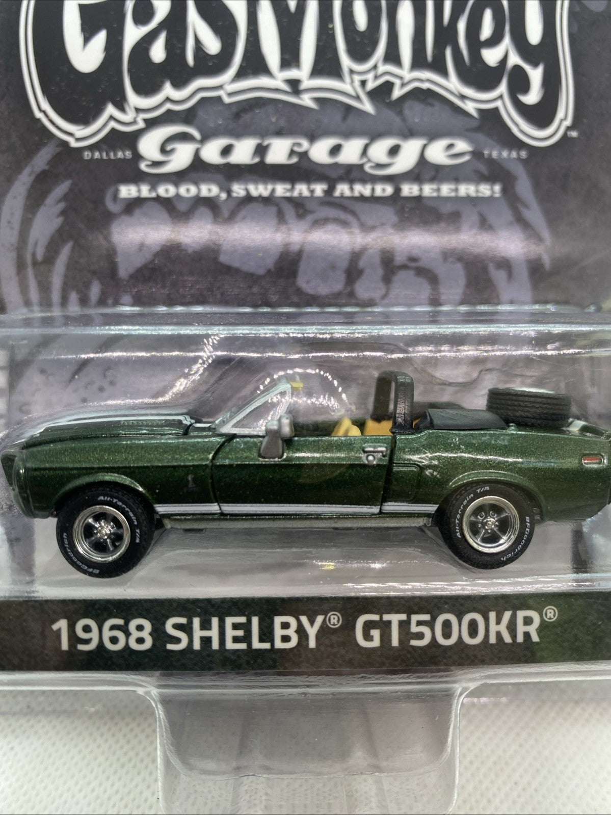 Close-up of green 1968 Shelby GT500KR convertible die-cast car in clear blister