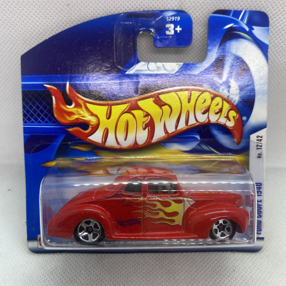 Hot Wheels red flame coupe toy car in clear blister pack on blue card